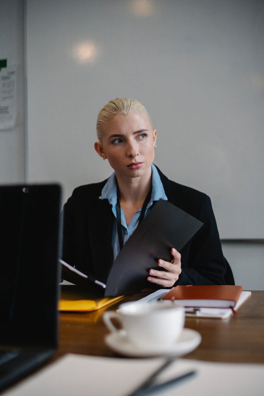 serious young businesswoman working in office with documents